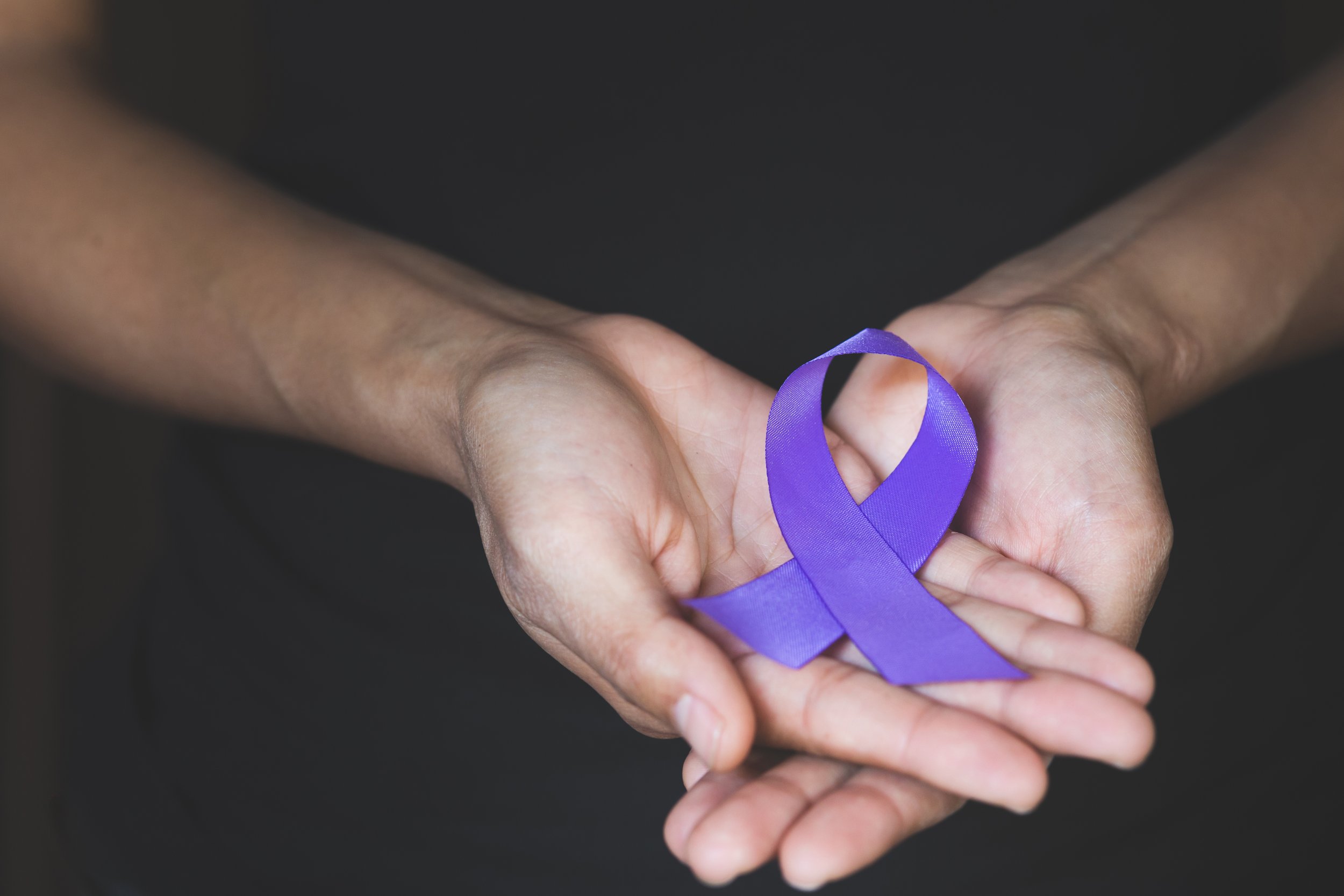 Woman Hand Holding Purple Ribbon, Domestic Violence Awareness Month (october) Concept With Deep Purple Awareness Ribbon.
